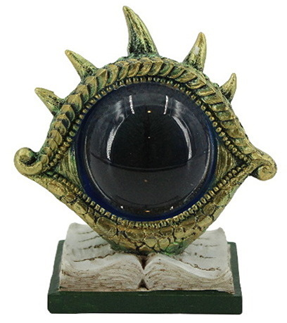 Figurine œil de dragon sur livre